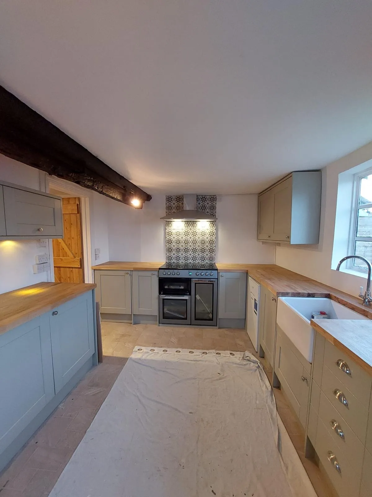 Completed kitchen with butler sink beneath the window